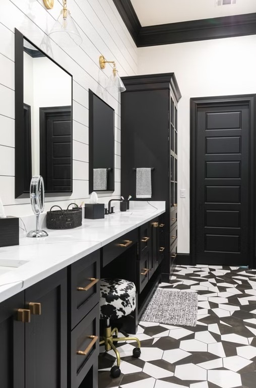 Luxury bathroom vanity featuring dual sinks, white custom cabinetry, and a thick marble countertop with elegant grey veining.