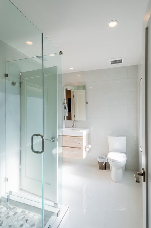 Luxury bathroom vanity featuring dual sinks, custom white cabinetry, and a thick marble countertop with elegant grey veining.
