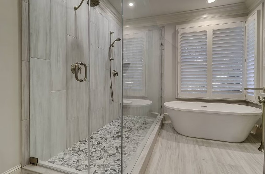 Luxury bathroom vanity featuring white cabinetry, a thick marble countertop, and large rectangular mirrors with contemporary vanity lighting.