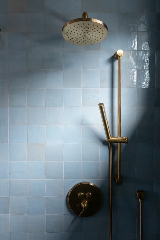 Luxury master bathroom featuring a freestanding white soaking tub, marble-tiled walls, and a large walk-in glass shower.