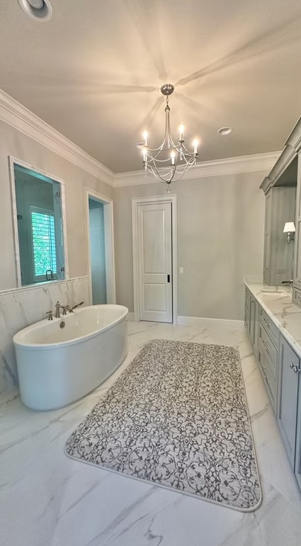 High-end bathroom vanity featuring dual sinks, custom white cabinetry, and a thick marble countertop with elegant grey veining.