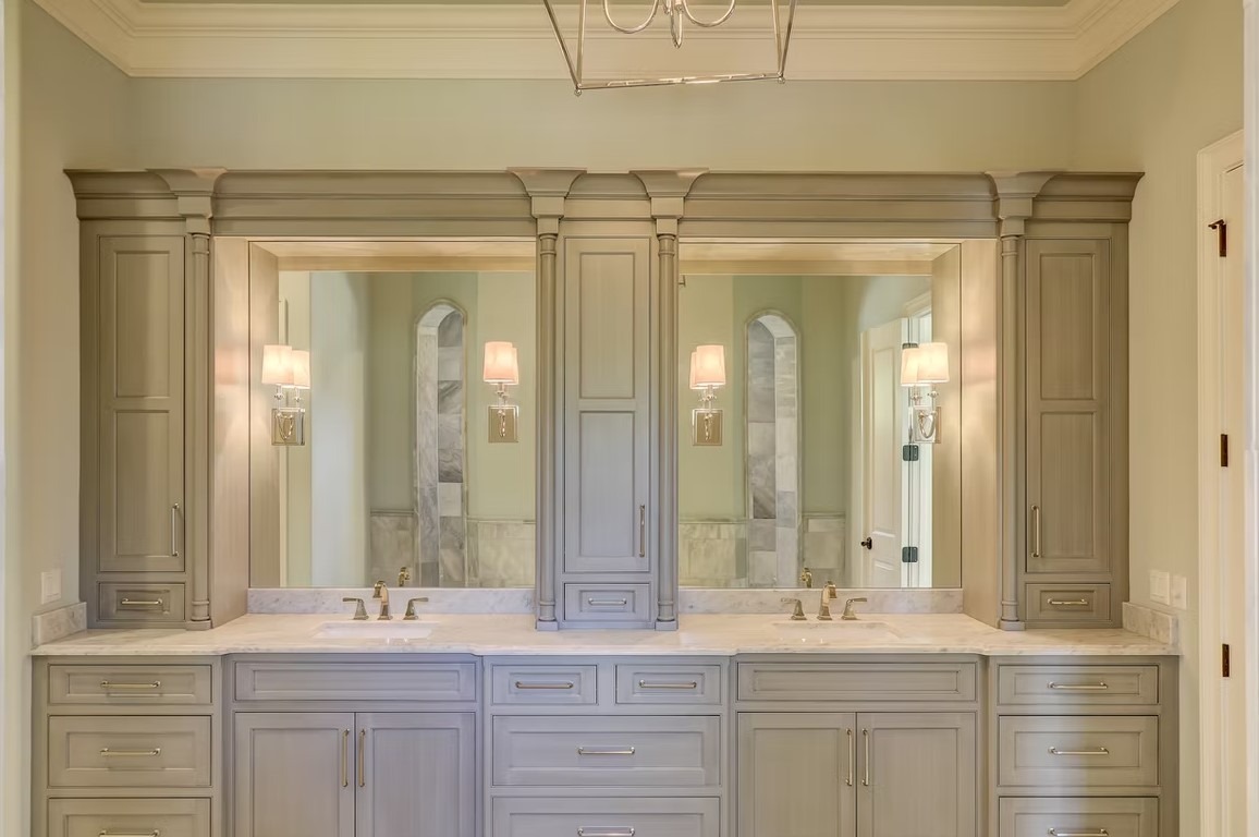 Luxury master bathroom featuring a white freestanding soaking tub, marble-tiled walls, and an expansive walk-in glass shower.
