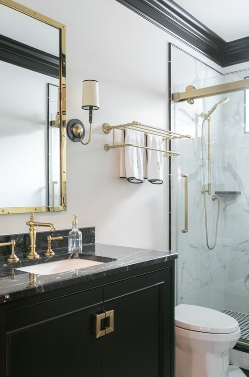 High-end bathroom vanity with dual sinks, white shaker-style cabinetry, and a thick marble countertop featuring grey veining.