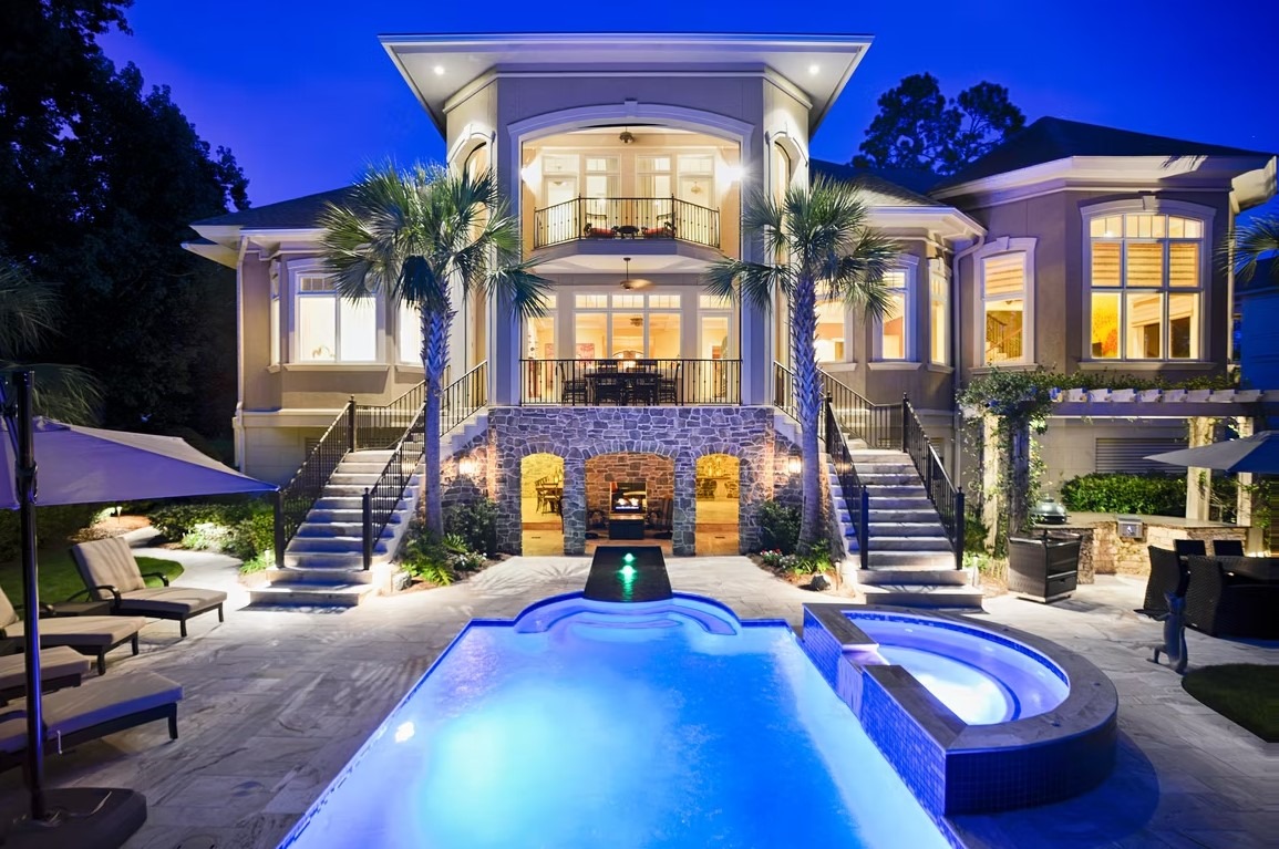 Front exterior of a luxury custom-built home on Hilton Head Island with coastal architectural details and professional landscaping.