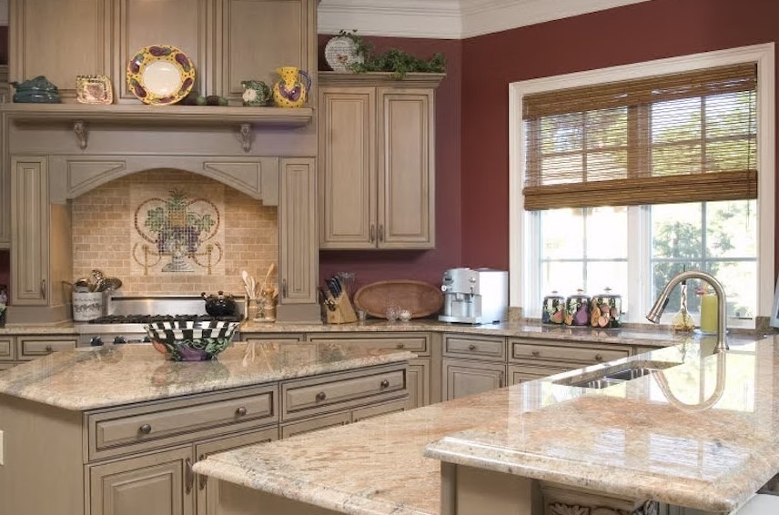 Luxury custom kitchen featuring a massive stone-topped center island, bespoke cabinetry, and contemporary pendant lighting.