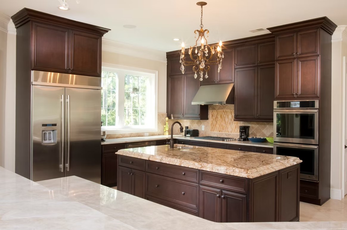 Luxury custom kitchen featuring elegant cabinetry, a large stone-topped center island, and designer lighting by Palatial Homes Design LLC.