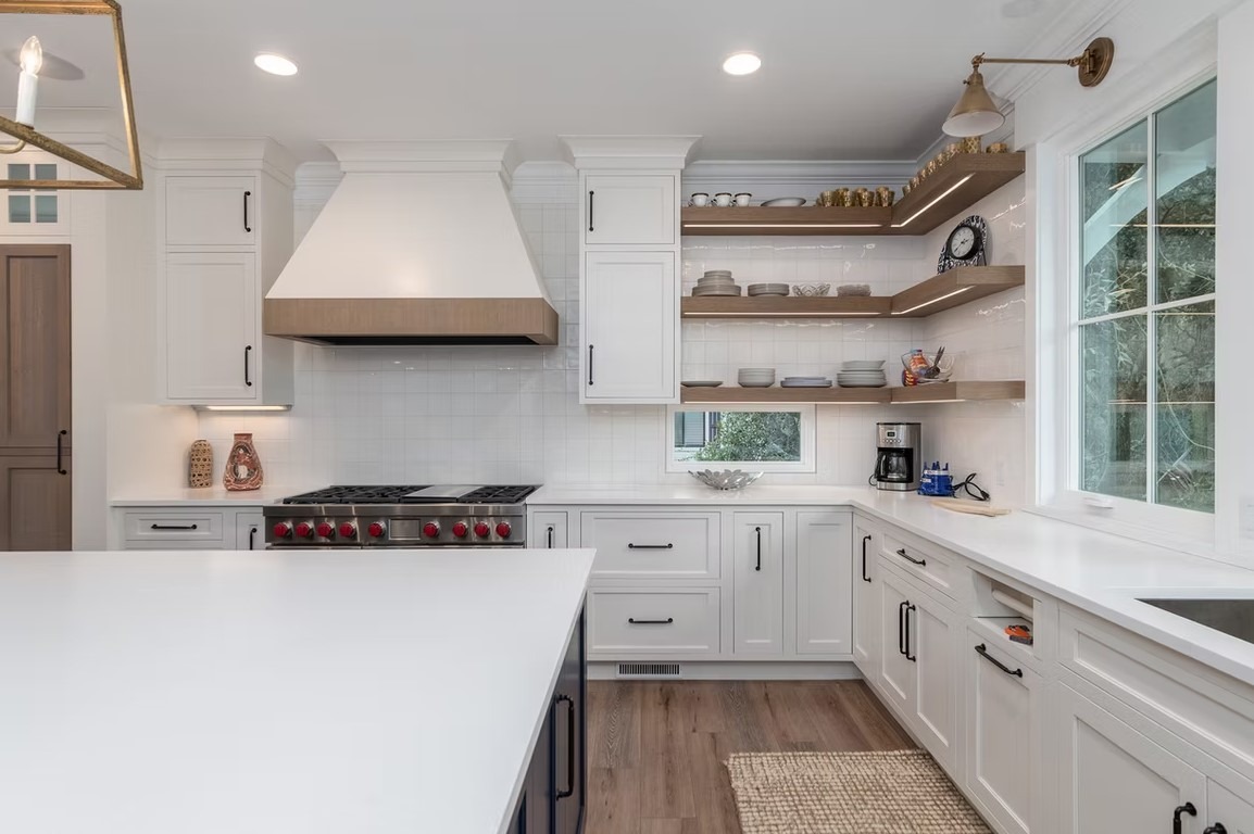 Luxury custom kitchen featuring high-end cabinetry, a large stone-topped island, and modern pendant lighting.