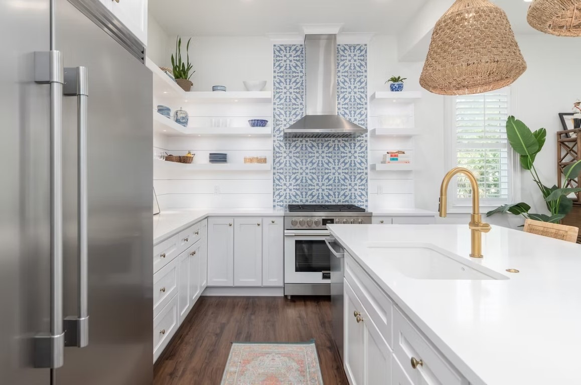 Luxury custom kitchen interior featuring sophisticated cabinetry, a large marble-topped island, and modern pendant lighting.